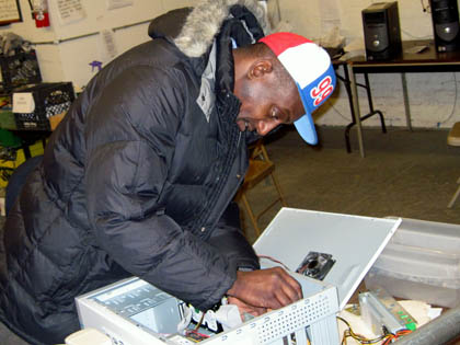 One of Nonprofit Technology Resource’s Tech-Redi workers repairs a computer.