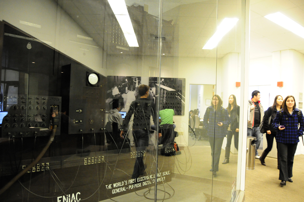 Engineering students at the University of Pennsylvania walk by a portion of the ENIAC in 2011.
