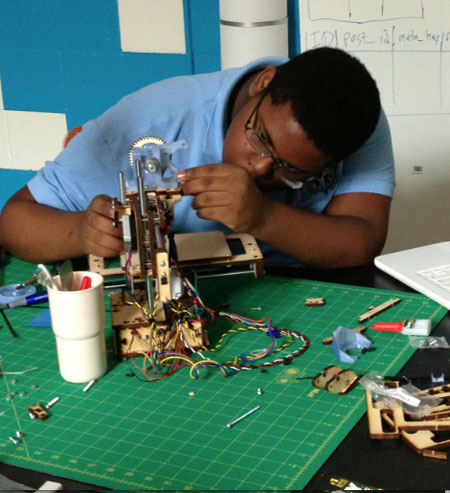 Darius McCoy working on the first Printrbot Jr. he assembled last spring. Photo credit: Digital Harbor Foundation.