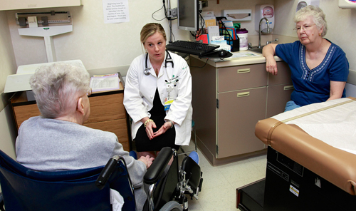 A Christiana Care doctor meets with a patient and a family member. 