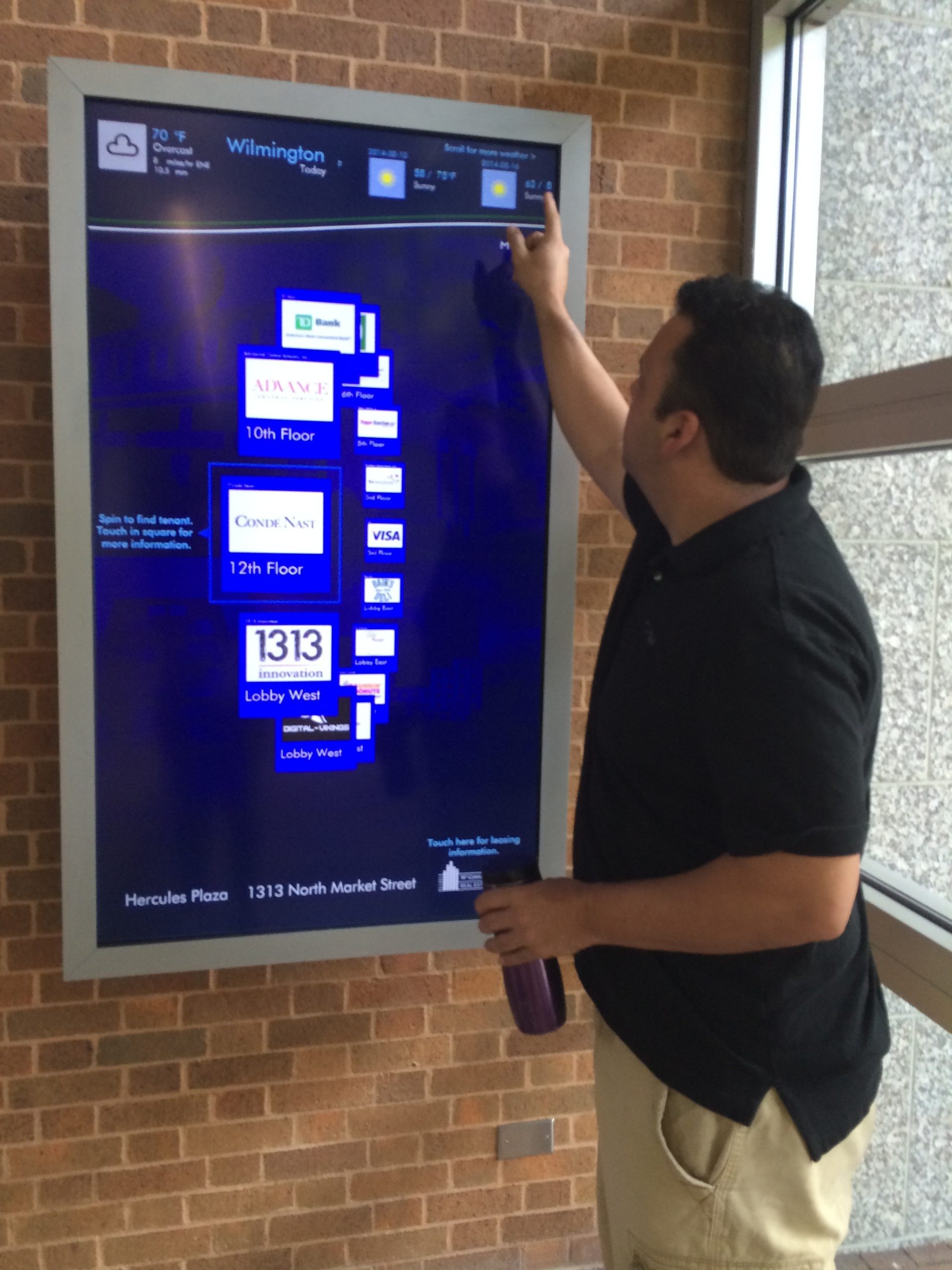 Richard Prieto uses the touch screen system his company installed at the Hercules Building, 1313 Market St., Wilmington.