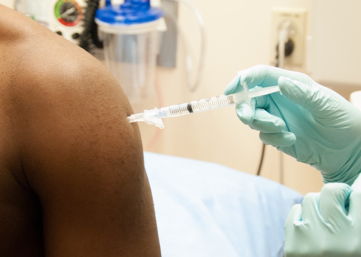 A 26-year-old man receives a dose of an investigational Ebola vaccine at the NIH Clinical Center in Bethesda, Md.