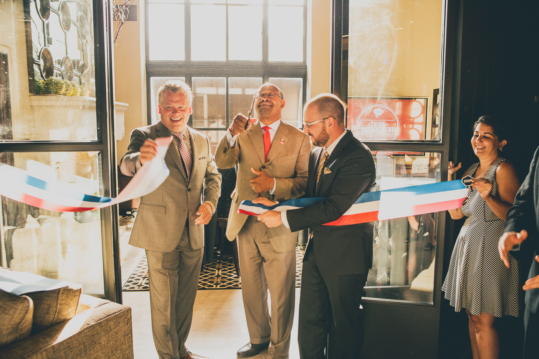 Philadelphia Mayor Michael Nutter, center, cuts the ribbon on creative agency Think Brownstone’s new Center City office, July 2014. At left, Think Brownstone cofounder Carl White.