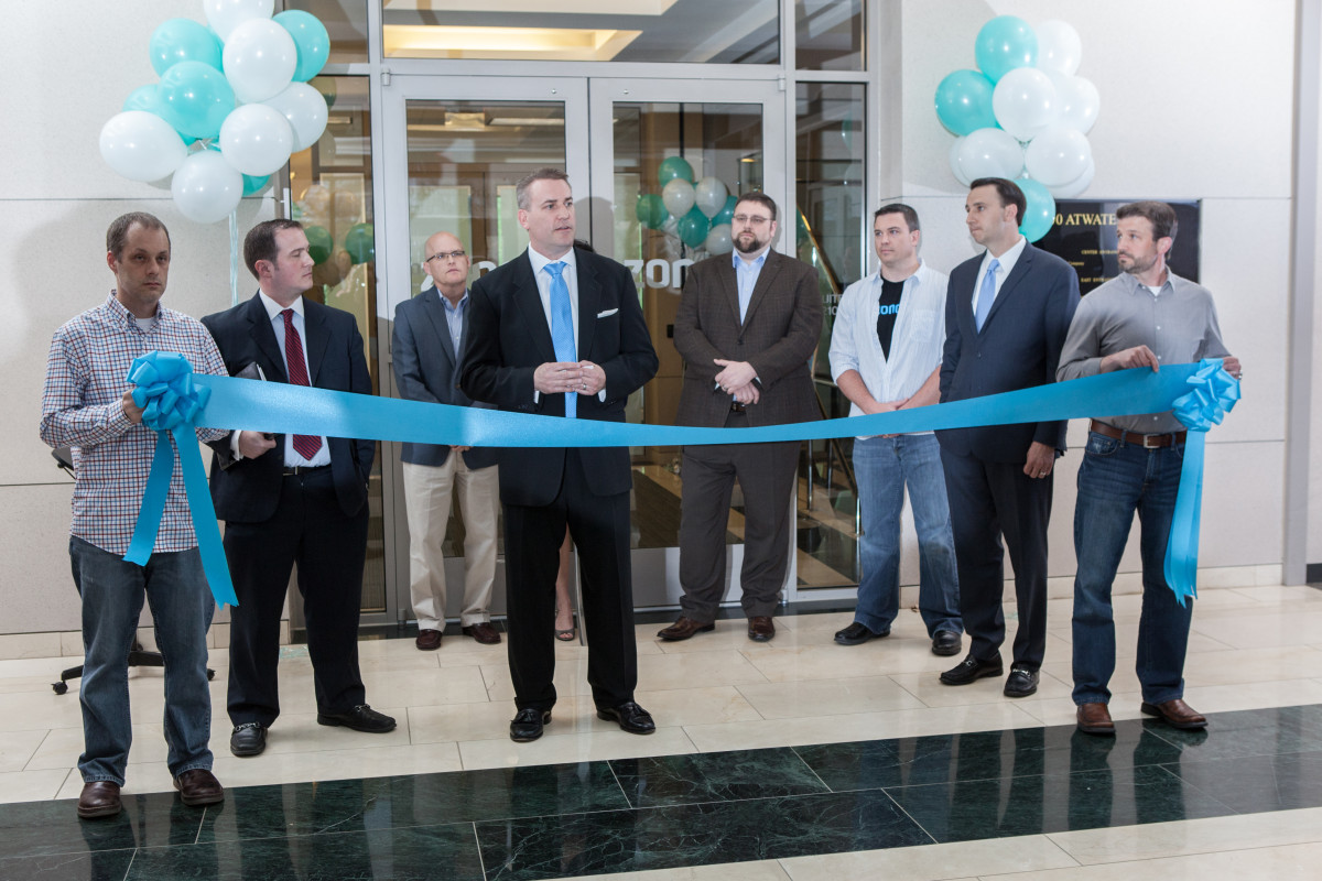 CEO Mike Harris (center) at the ribbon cutting of Zonoff’s new office.