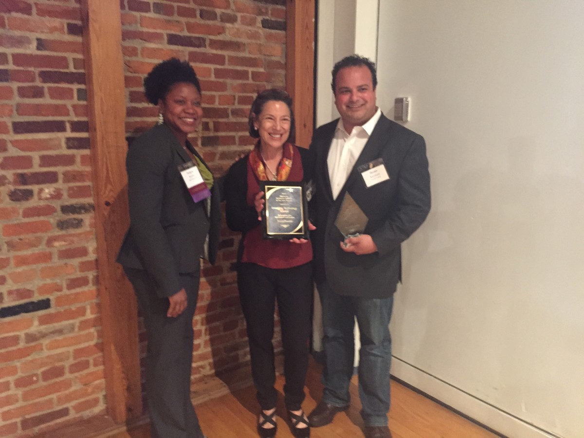 SocialToaster CEO Brian Razzaque (right) and ETC President Deb Tillett (center) with the Tech Company of the Year Award, presented by Jacqueline Brooks of Saul Ewing.