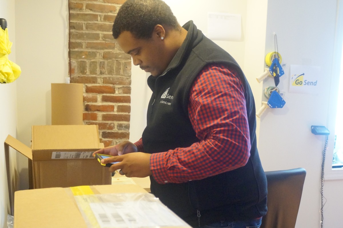 Ryan Williams processes an incoming GoSend package.
