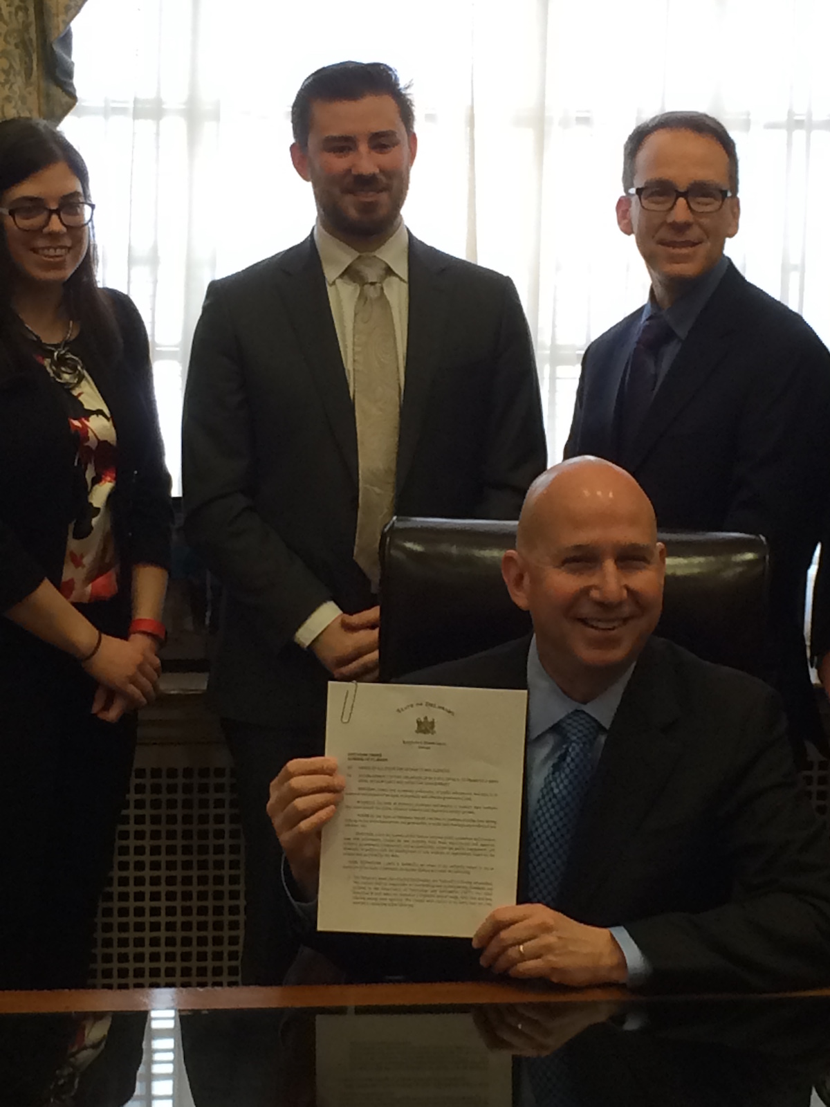 Gov. Jack Markell holds up the open data executive order.