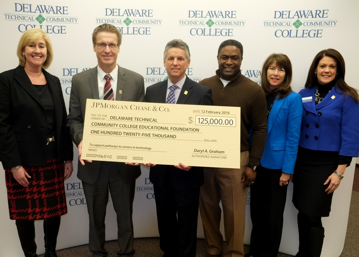 Delaware Tech's president, Mark Brainard (center), holds the big check from the JPMorgan Chase Foundation.