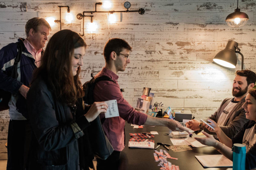 Attendees approach the registration table at NET/WORK Brooklyn 2017, which was hosted by CoLab-Factory.