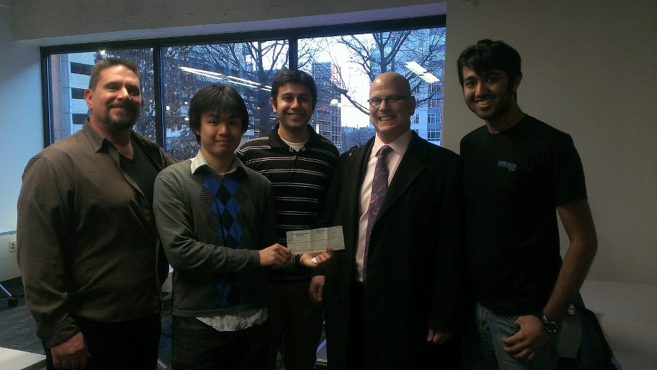 Yuriy with organizers of nvigor upon receiving their first sponsorship check in 2013.