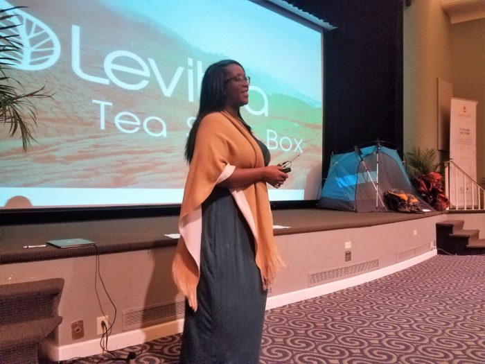 A woman speaks to a crowd