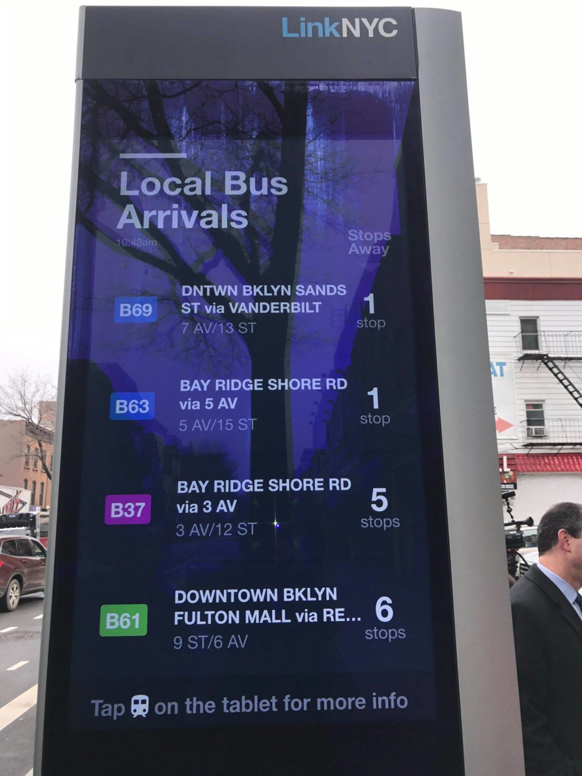 A LinkNYC kiosk with bus countdown clock.