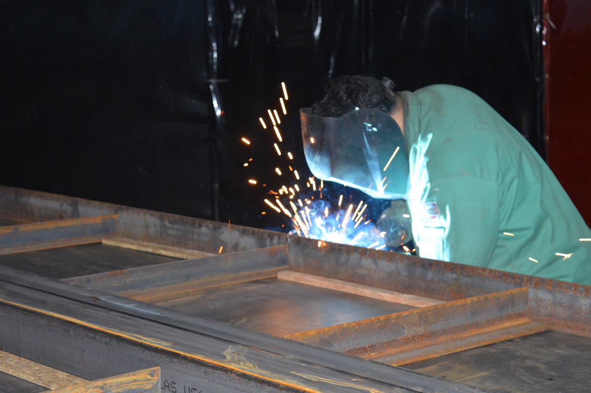 A Full Stack Modular worker welds the steel frame of one of the company’s housing units.