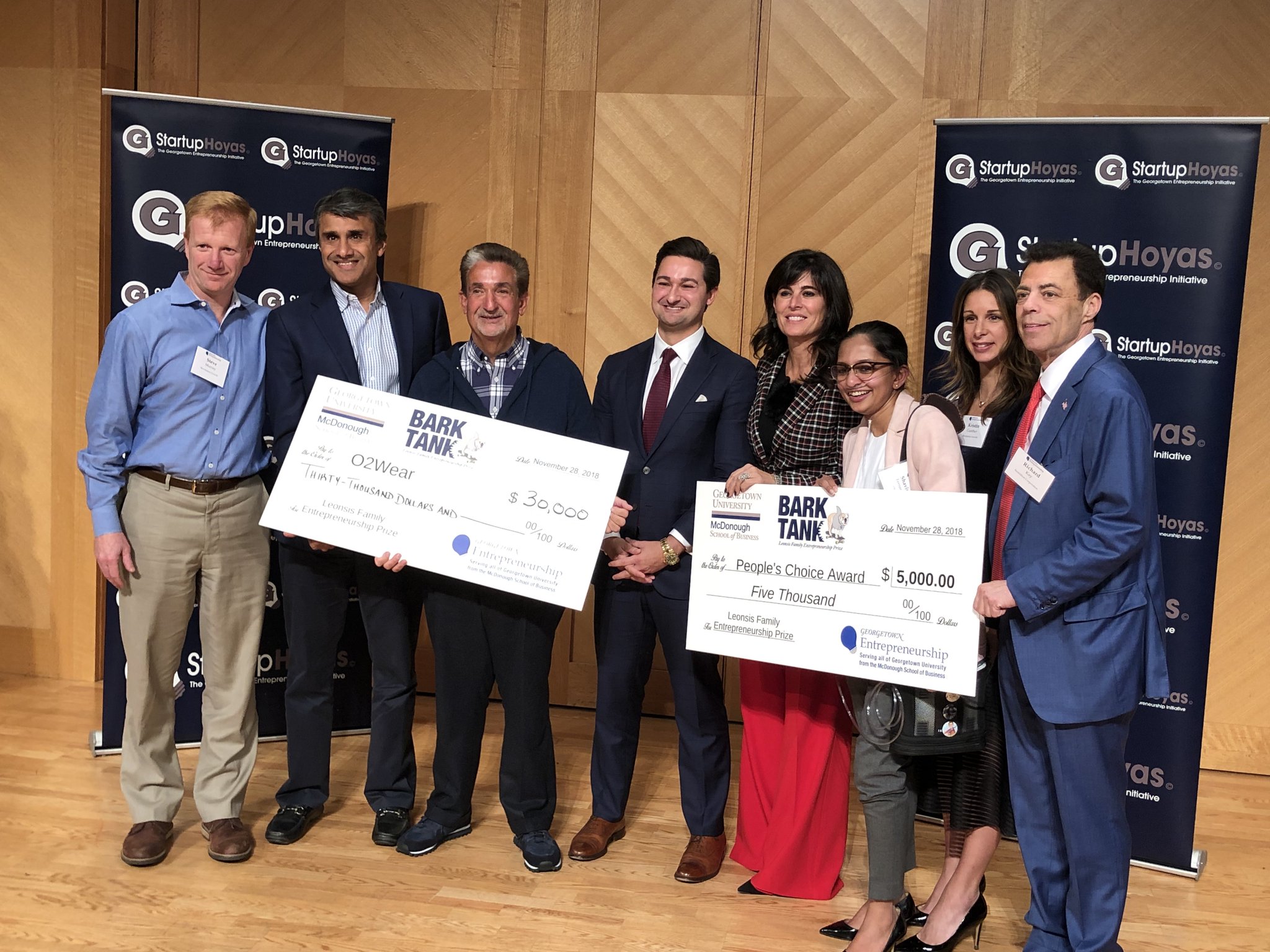 Shavini Fernando, O2 Wear foudner and CEO, accepting her cash prizes at the second annual Leonsis Family Entrepreneurship Prize “Bark Tank” pitch competition.