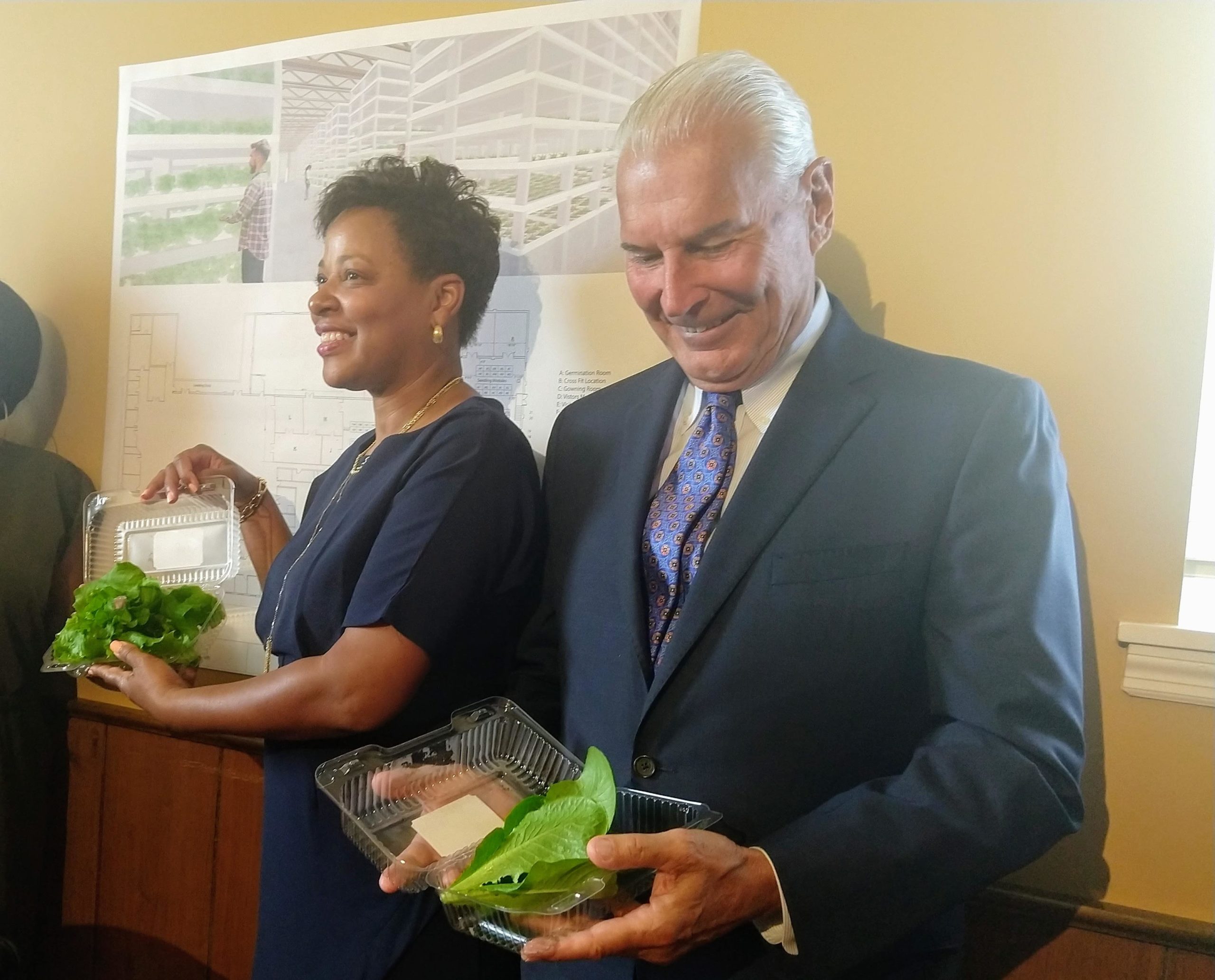 The mayor’s chief of staff Tanya Washington and Mayor Mike Purzycki show off recently harvested hydroponic  lettuce from Second Chance Farms.