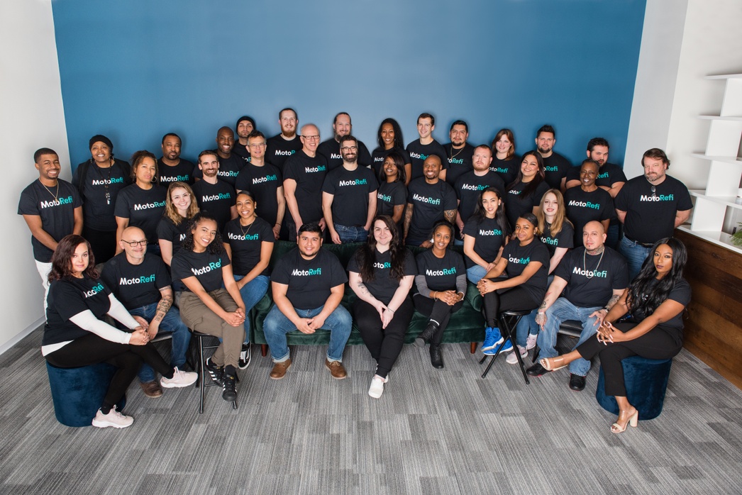Members of the Caribou team sit for a company photo