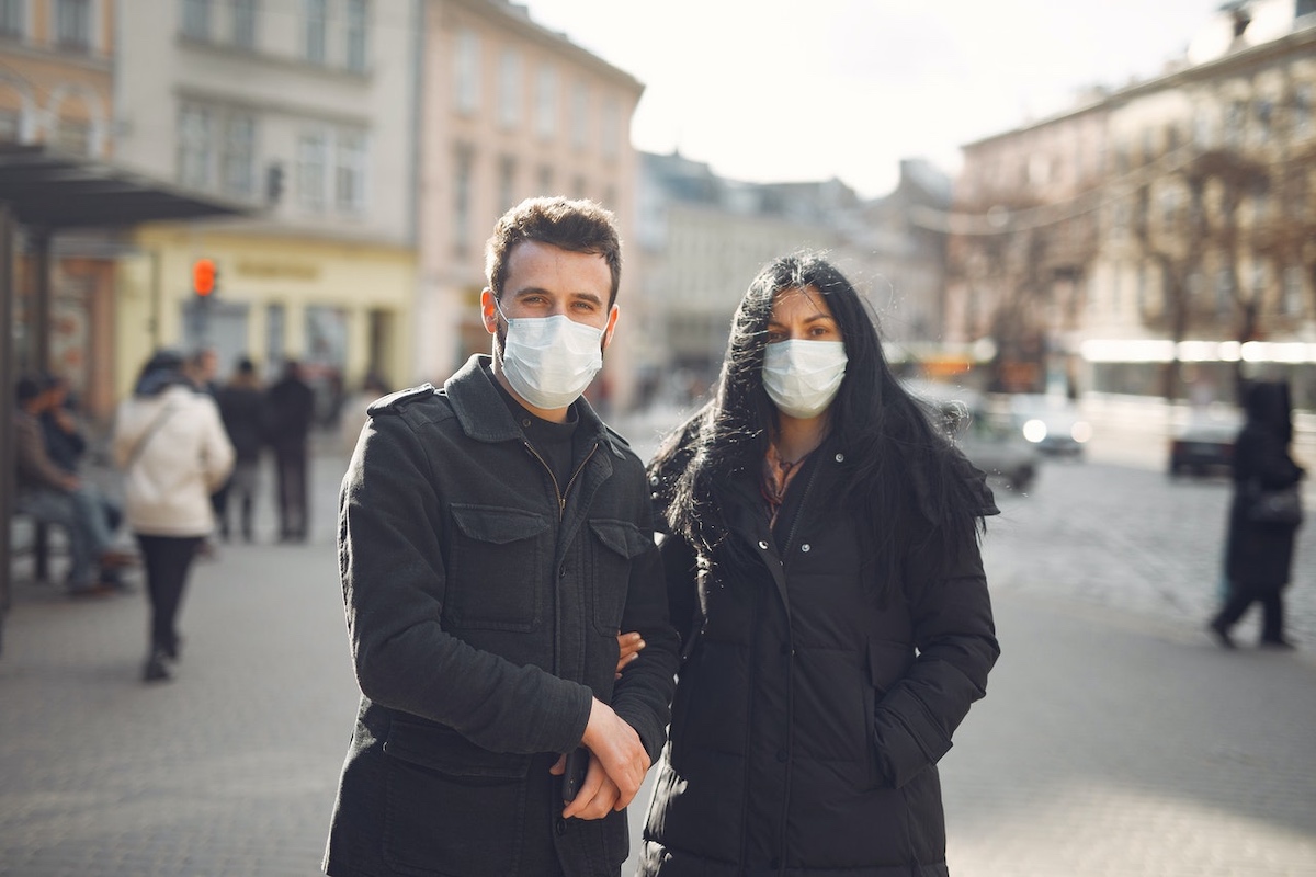 Two young people wearing masks.