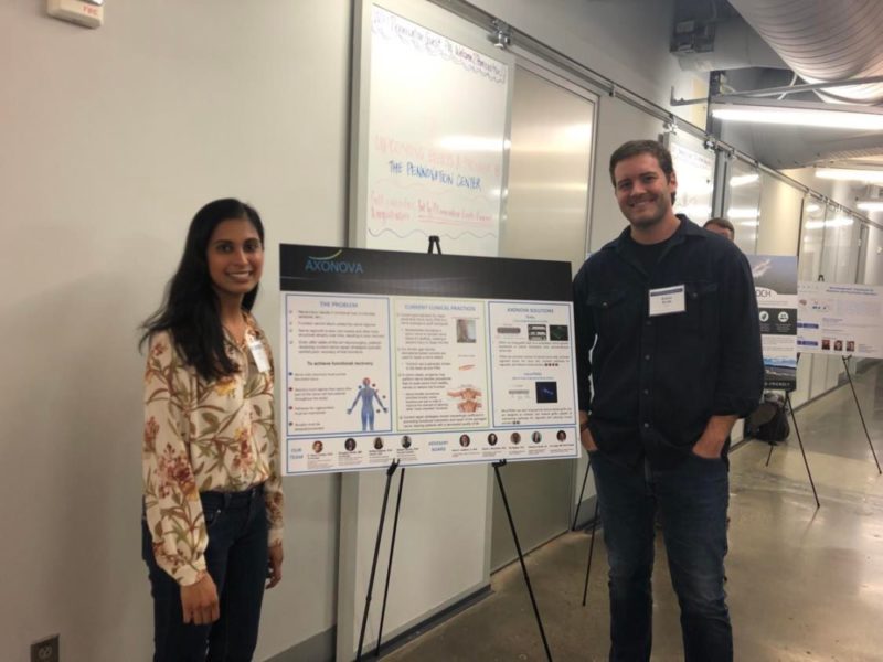Kritika Katiyar and Robert Shultz standing in front of a poster on a easel