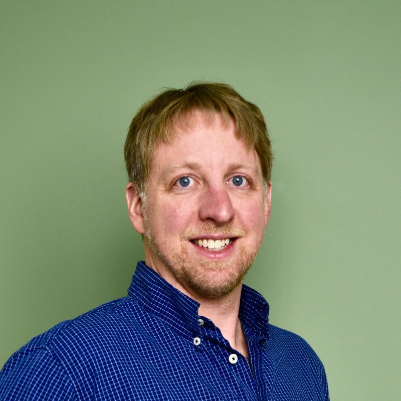 Christian Heinzmann in front of a green background