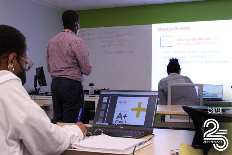 Byte Back students sit in front of laptops in a classroom