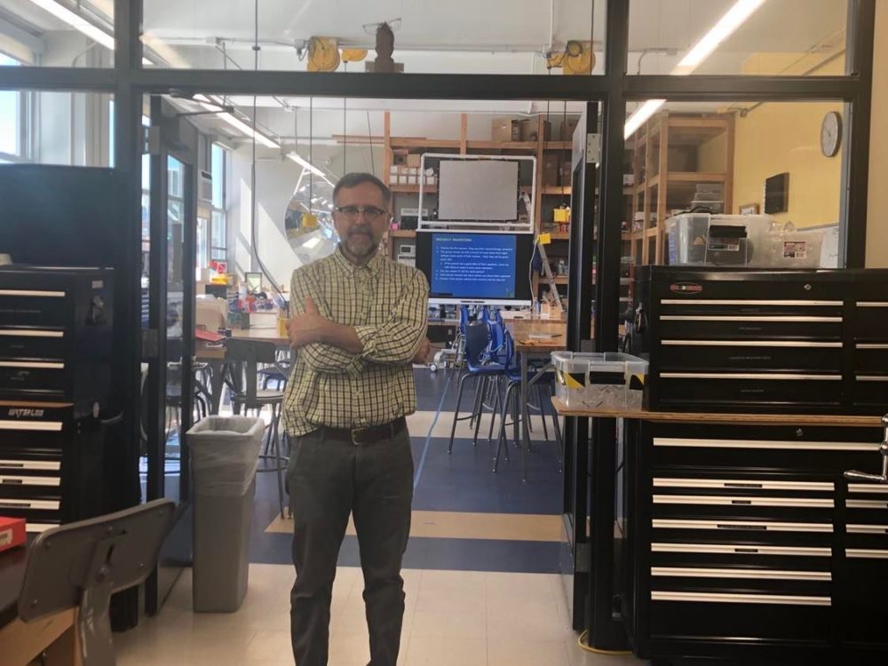 John Kamal stands in front of his engineering shop