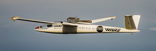 White and black aircraft in front of blue sky