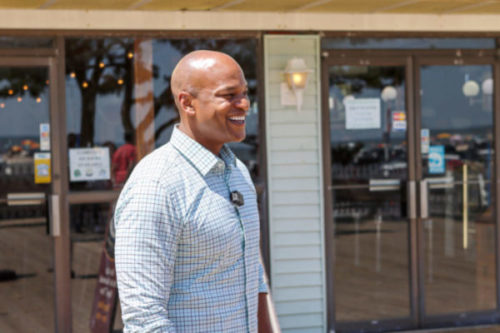 Wes Moore stands in front of an Ocean City busines.