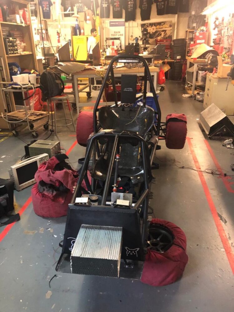 A racecar in a workshop.