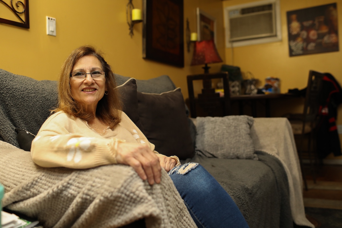 A woman sitting on a couch in a living room.