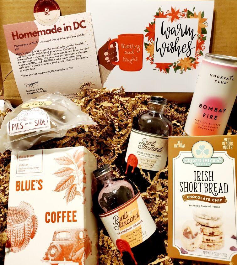 An open cardboard box with local coffee, simple syrups, Irish shortbread cookies and more.