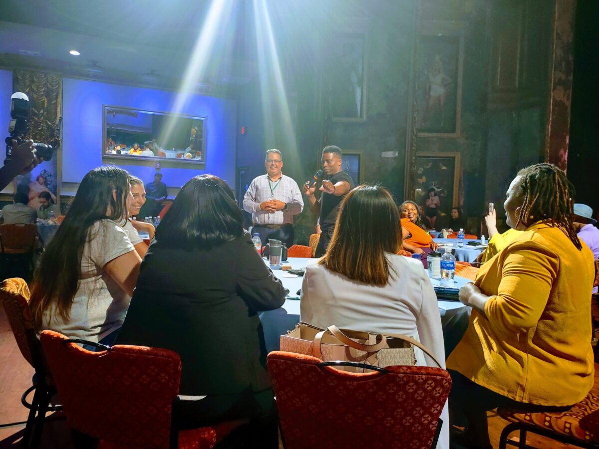 Attendees at a table doing a teambuilding game.