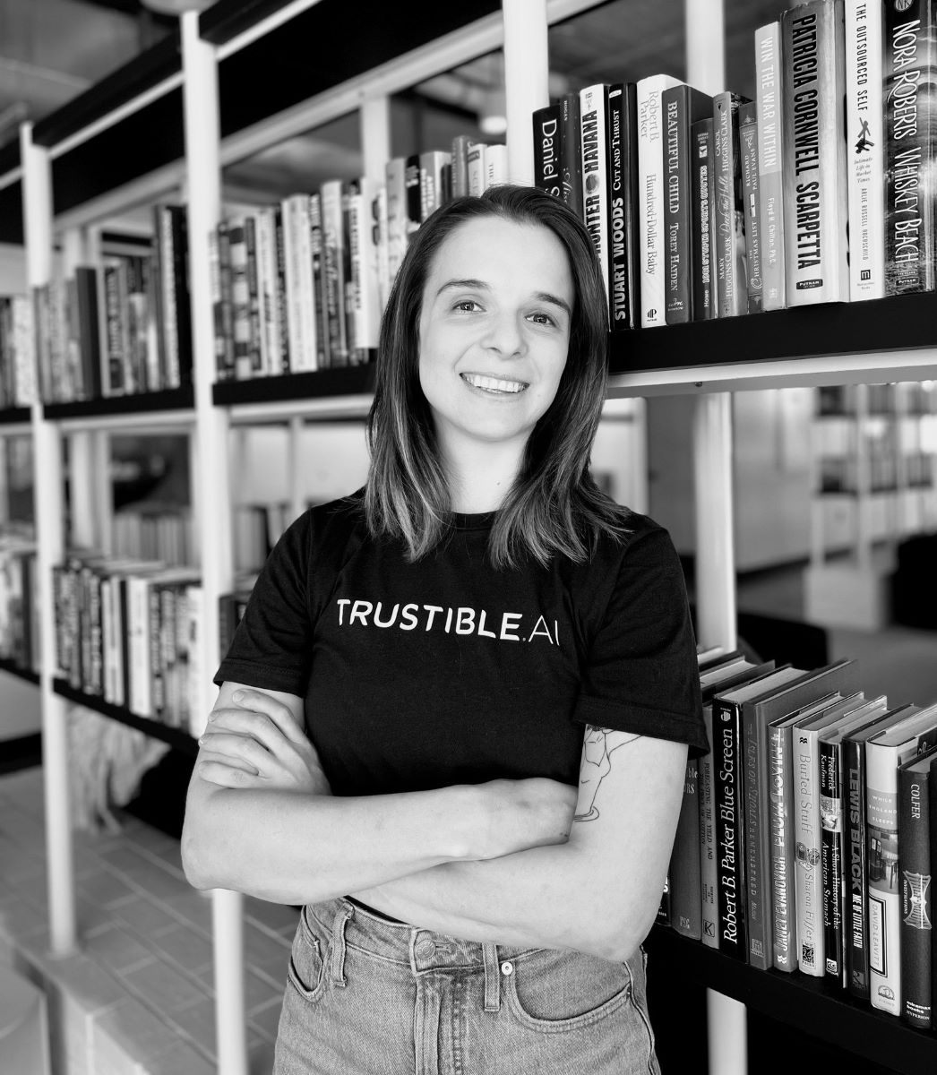 Anastassia Kornilova poses in front of bookshelves. 