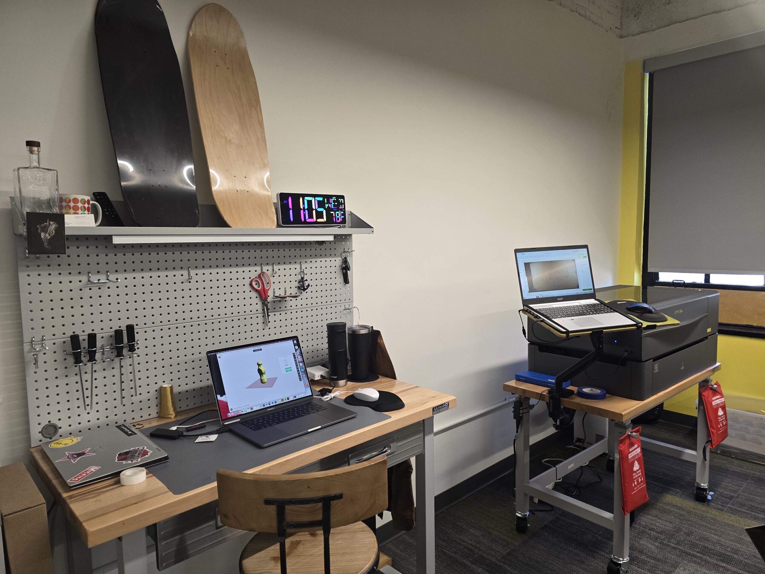 A desk with a laptop and a skateboard on it.