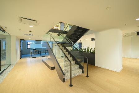 A glass stairway leading to a wooden floor.