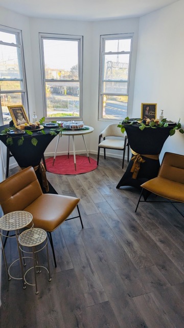 Room with chairs and tables in front of a window. 