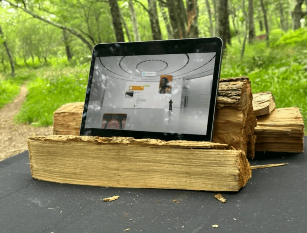 Apple Intelligence platform on black tablet that's placed on brown wood logs.