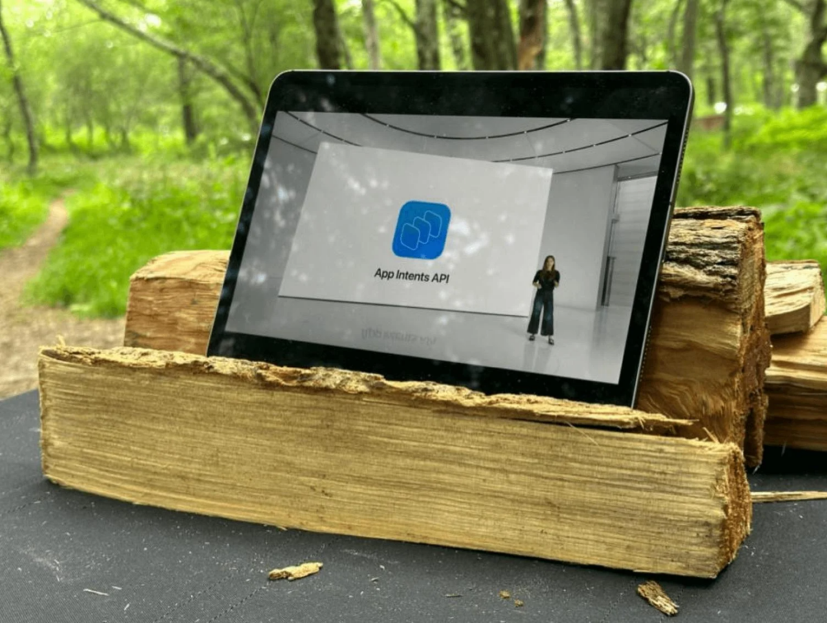 App Intents platform on black tablet that's placed on brown wood logs.