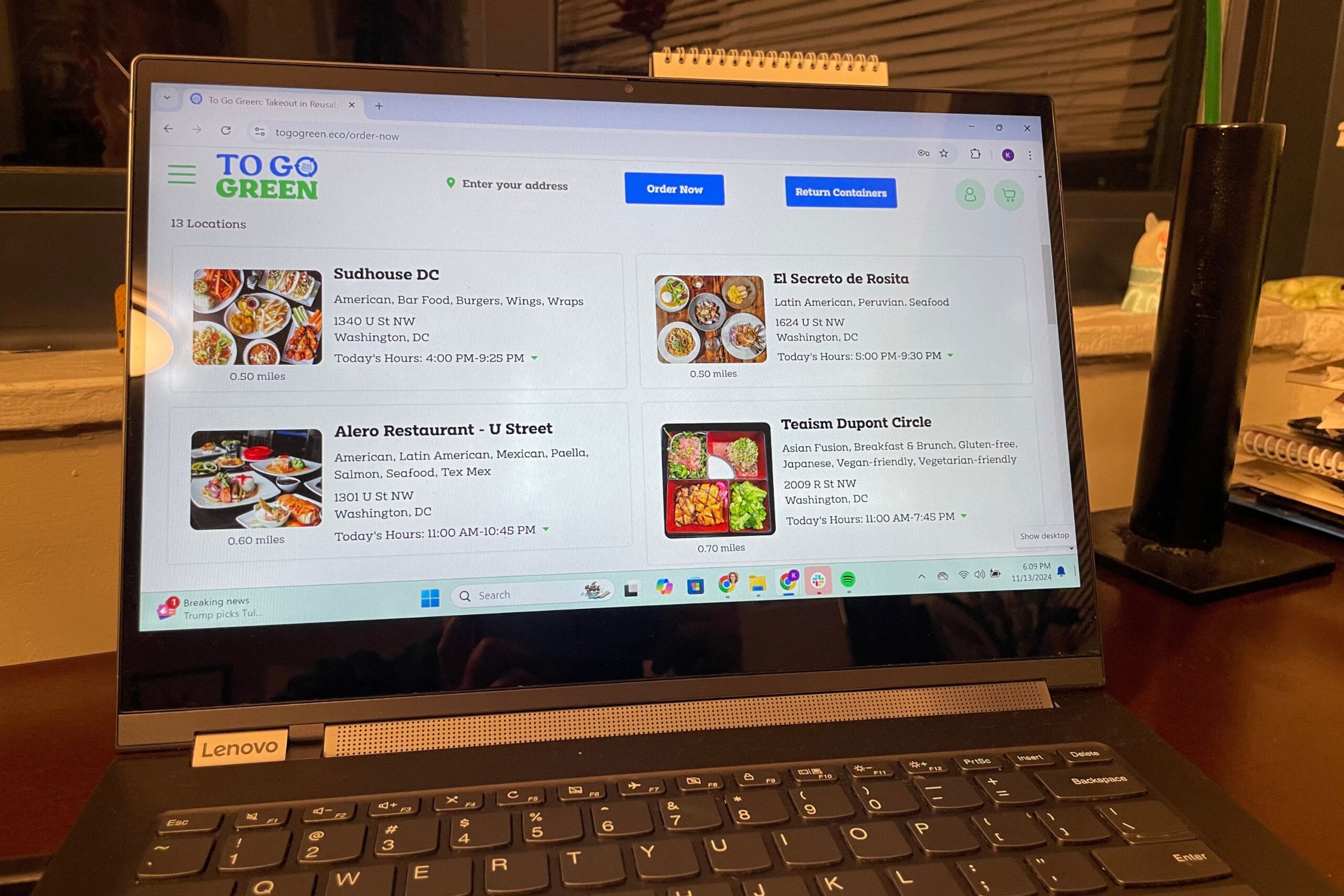 A laptop screen displays a food delivery website called "TO GO GREEN," showing restaurant options with their respective names, cuisines, and operating hours.